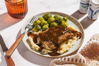 Grilled Pork Chop with Potato mash, Brussel Sprouts, and Onion Gravy